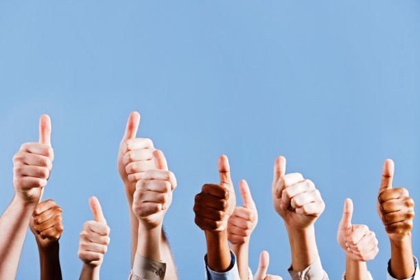 Arms up in the sky giving the thumbs up