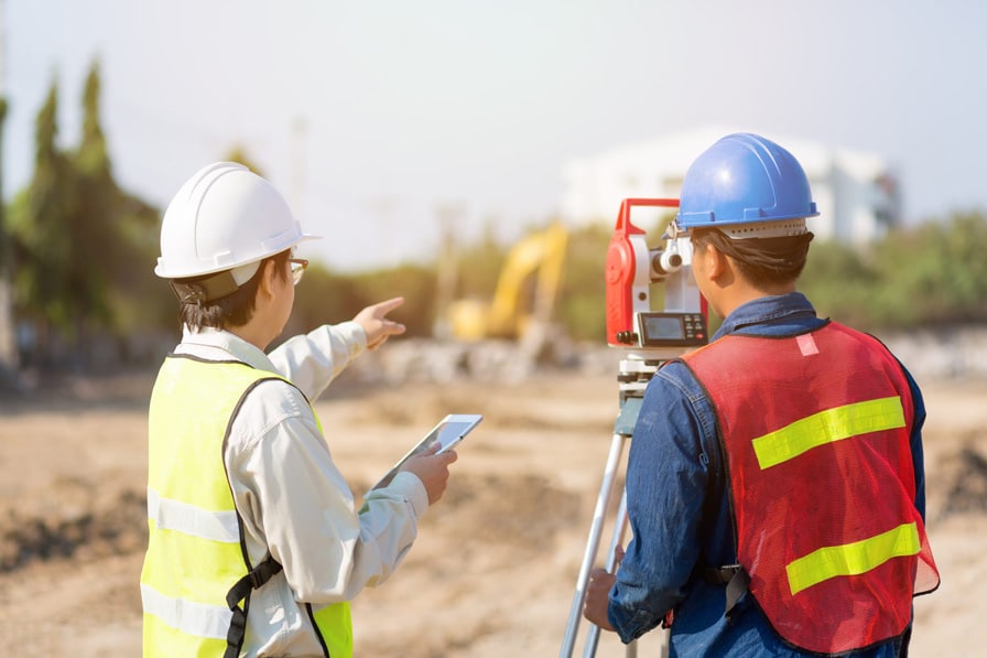 Asian Civil engineer and Asian foreman worker checking construction site for new Infrastructure construction project.